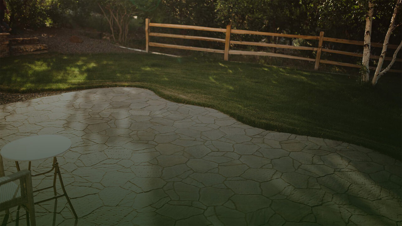 backyard with stone patio and wooden fence